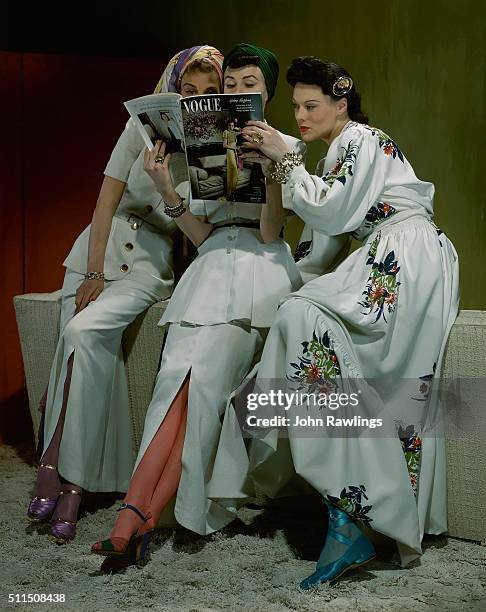 Three models lean in to read a Vogue magazine together.