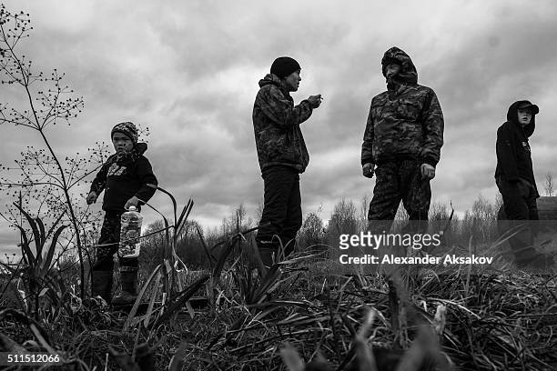 Kids talk on the shore of river Laima in the village of Varmakhli, Nijnetavdinski district, Tyumen oblast, Russia. A boy on the left came to the...