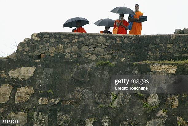 Monks watch play during the fifth day of the first Test match between Sri Lanka and South Africa on August 8, 2004 at the International Stadium in...