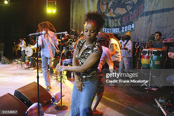 Backup singers for the Marley brothers sing along with Julian Marley, son of Bob Marley, onstage at the "Roots, Rock, Reggae Tour 2004" at the Filene...