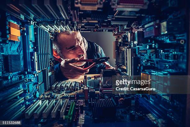 technology versus man - mother board stock pictures, royalty-free photos & images