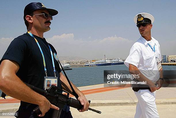 Greek Navy officer, together with special police, secure the 2004 Olympic Games zone in the port of Pireaus, on August 9, 2004 where luxury liners...