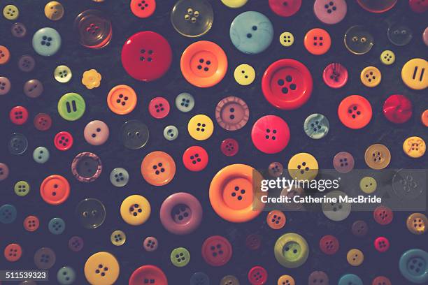 colourful buttons on a black background - catherine macbride 個照片及圖片檔