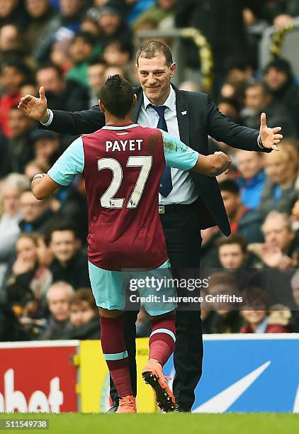 Dimitri Payetof West Ham United celebrates with Slaven Bilic manager of West Ham United after scoring his team's second goal from a free kick during...