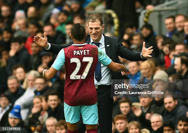 Dimitri Payetof West Ham United celebrates with Slaven Bilic manager of West Ham United after scoring his team's second goal from a free kick during...