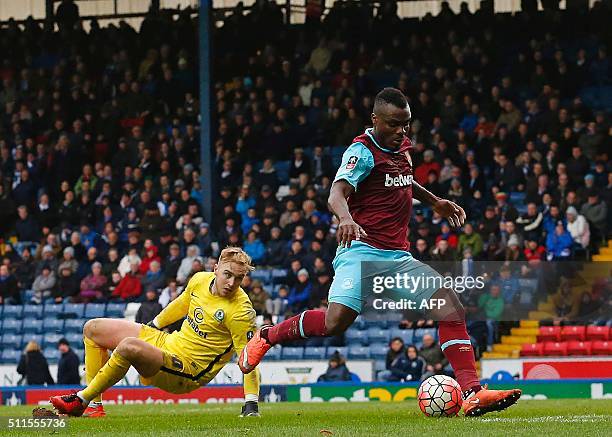 West Ham United's Nigerian striker Emmanuel Emenike scores their fourth goal during the FA cup fifth round football match between Blackburn Rovers...