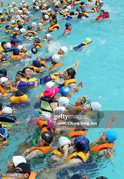 South Koreans enjoy a swim at Everland amusement park on August 10, 2004 in Yongin, South Korea. The Caribbean Bay, water park section of Everland...