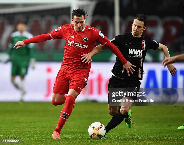 Edgar Prib of Hannover is challenged by Markus Feulner of Augsburg during the Bundesliga match between Hannover 96 and FC Augsburg at HDI-Arena on...