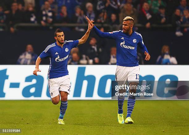 Younes Belhanda of Schalke celebrates with team mate Maxim Choupo-Moting as he scores their first goal during the Bundesliga match between FC Schalke...