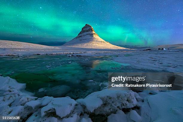 aurora over kirkjufell mountain iceland - frozen waterfall stockfoto's en -beelden