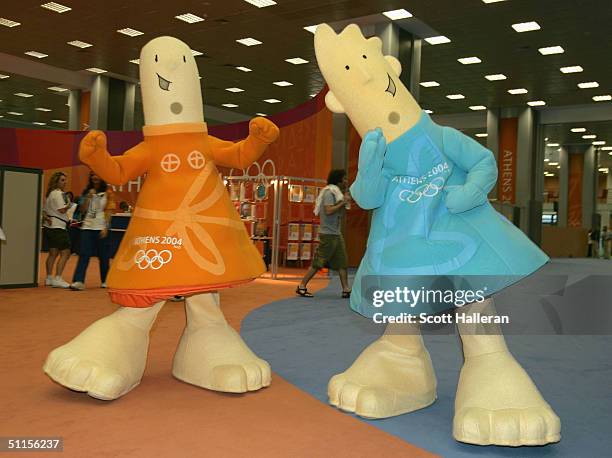 The Offical Mascots of the Athens 2004 Olympic Summer Games Athena and Phevos walk through the lobby of the Main Press Center prior to the start of...