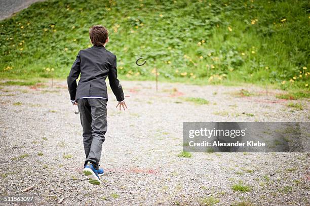boy throwing a horseshoe - norwegian national day stock pictures, royalty-free photos & images