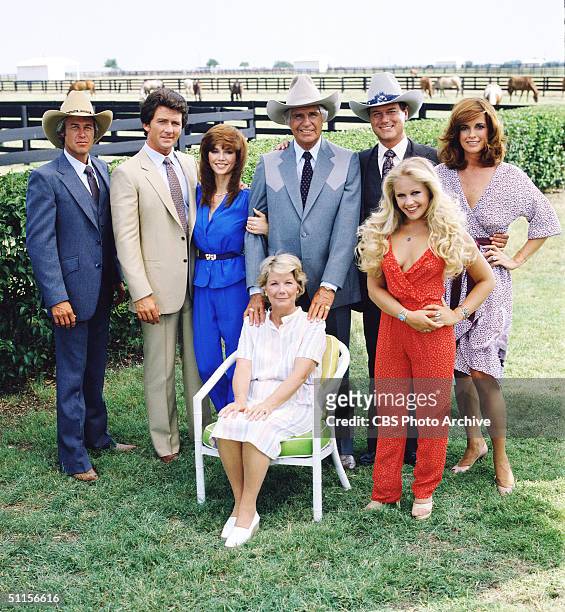 Promotional still from the American television series 'Dallas' shows the cast assembled on the property of the Southfork ranch, on the outskirts of...