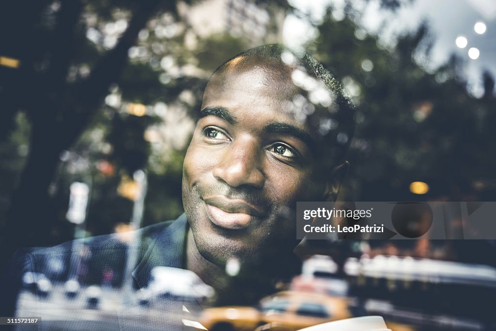 Portrait of a man on the window of a cafe