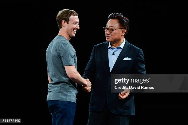 Founder and CEO of Facebook Mark Zuckerberg and President of Mobile Communications Business of Samsung DJ Koh shake hands during the presentation of...