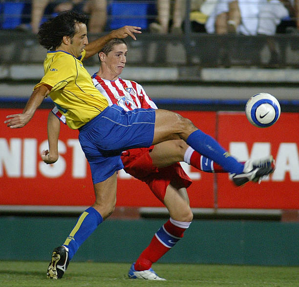 Villarreal's Quique Alvarez fights for the ball with Atletico de Madrid's Fernando Torres during their first leg Intertoto final round match in...
