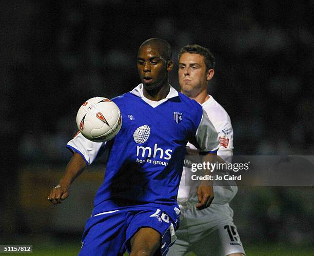 Darren Byfield of Gillingham shields the ball from Danny Pugh of Leeds during the Coca-Cola Championship match between Gillingham and Leeds United at...