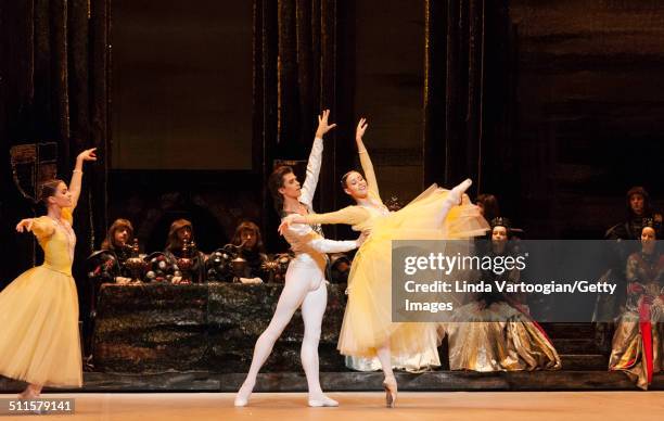 Russian dancers Maria Vinogradova and Kristina Kretova perform, with Artem Ovcharenko in the Bolshoi Ballet production of 'Swan Lake' during the...