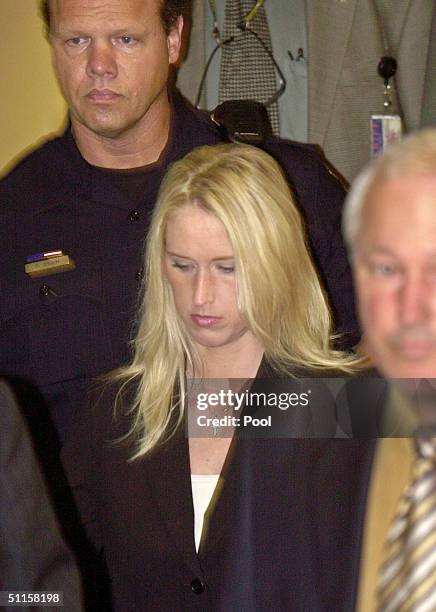 Amber Frey looks down as she leaves a Redwood City, California courtroom after testifying at the Scott Peterson trial August 10, 2004 in Redwood...