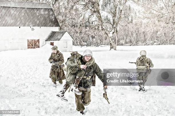 soldiers in wwii evacuating a wounded team member - weather alert stock pictures, royalty-free photos & images