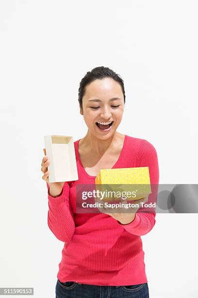 young woman opening box - women open mouth stock pictures, royalty-free photos & images