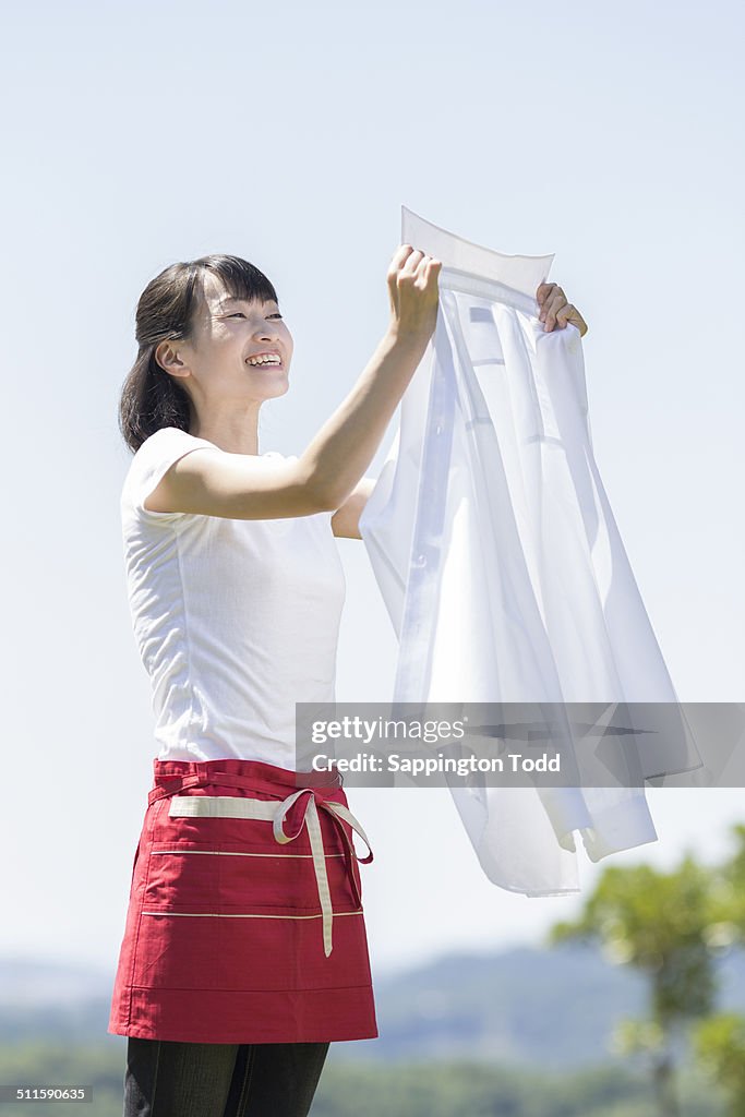 Woman Holding White Shirt