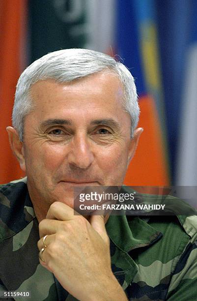 Commander of the Eurocorps General Jean-Louis Py gestures during a press breifing in Kabul, 11 August 2004. General Jean-Louis PY, commander of the...