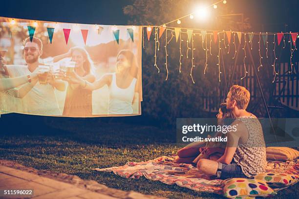 romantic movie night - loving 2016 film stock pictures, royalty-free photos & images