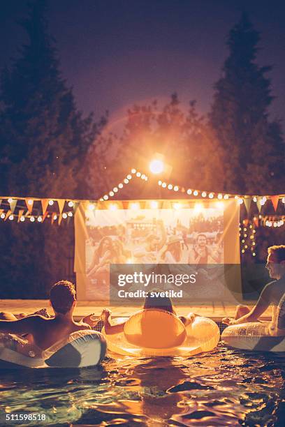 pool movie night party - swimming pool night stock pictures, royalty-free photos & images