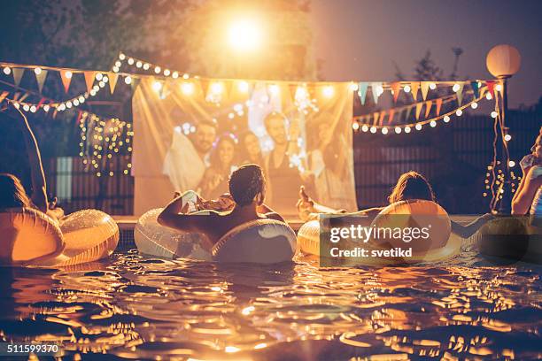 pool movie night party - pool party night stock pictures, royalty-free photos & images