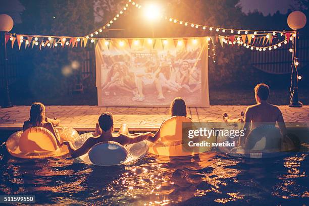 pool movie night party - pool party night stock pictures, royalty-free photos & images