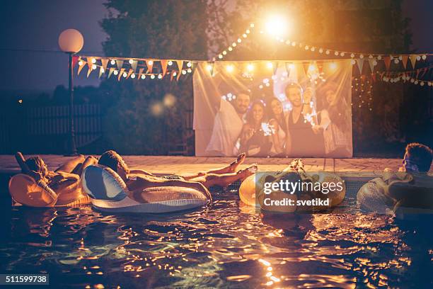 pool movie night party - pool party night stock pictures, royalty-free photos & images