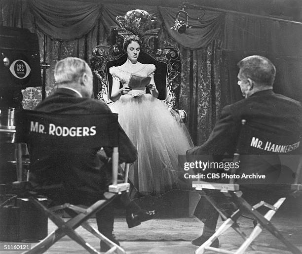 American composers Richard Rodgers and Oscar Hammerstein II watch British actress Julie Andrews read her script on the set of the CBS Television...