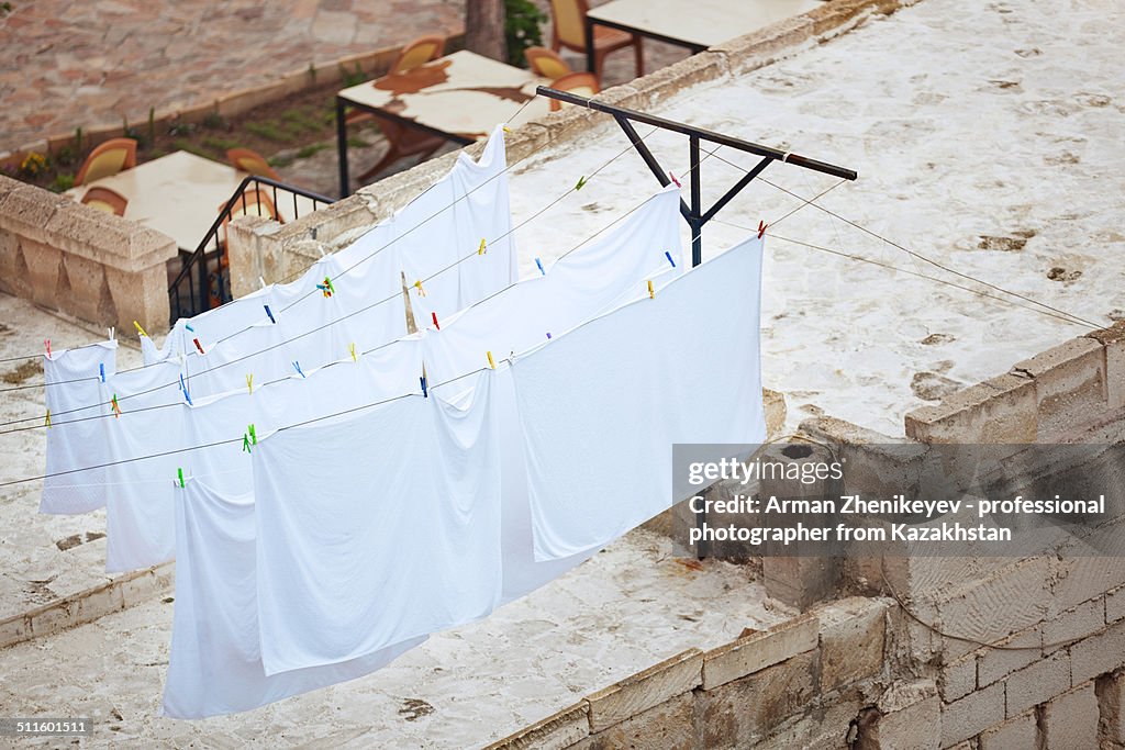 Drying linen hanged on a roof of house