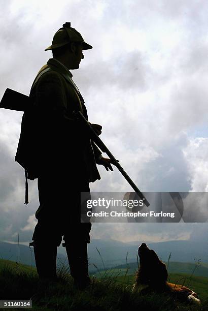 Gamekeeper Kyle Hogg and his gun dog Teal prepare for tomorrow's start of the grouse shooting season, on August 11, 2004 on a moor outside Peebles,...