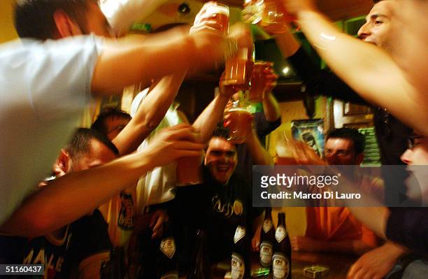 Italian students from the Primo Levi Technical Institute of Vignola in the Modena Province, toast with glasses of beer in a pub during a school trip...