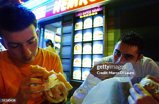 Alessandro Ghibellini and Claudio Ratti Italian students from the Primo Levi Technical Institute of Vignola in the Modena Province, eat hamburgers at...