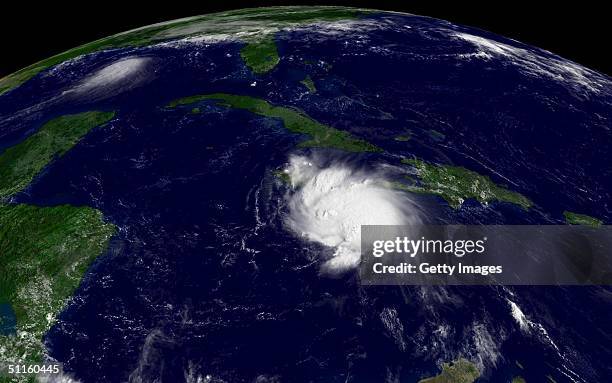 This satellite handout from the National Oceanic and Atmospheric Administration shows Tropical Storm Charley bearing down on Jamaica the morning of...