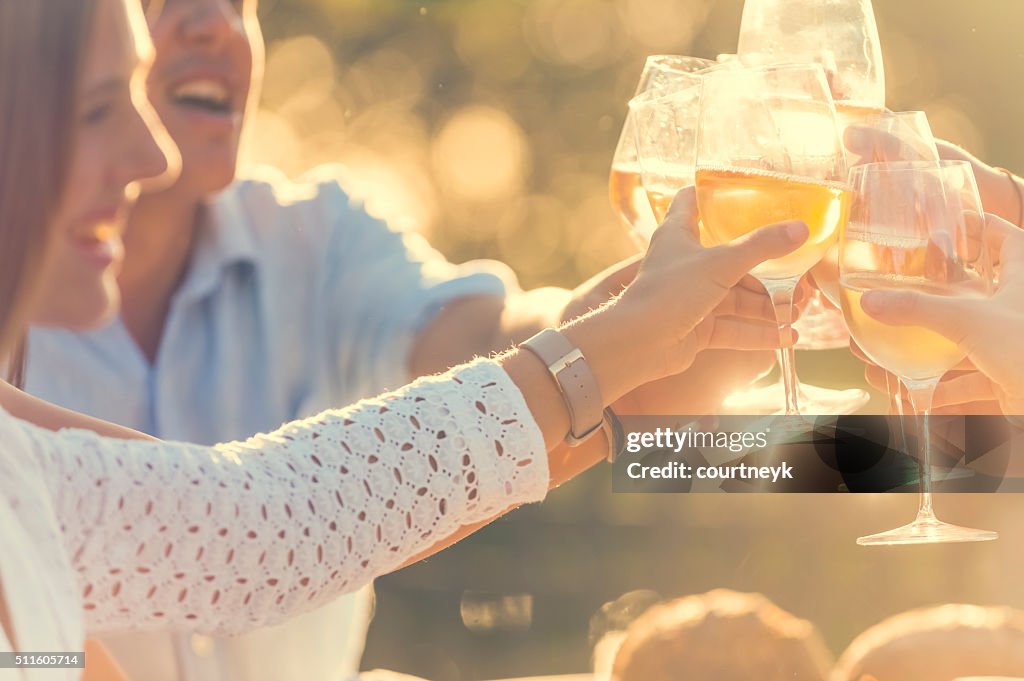 Group of friends having drinks at sunset.