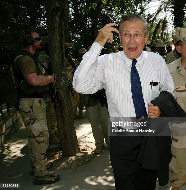 Secretary of Defense Donald Rumsfeld gestures after visiting the Afghan Provincial Reconstruction Team August 11, 2004 in Jalalabad, Afghanistan....