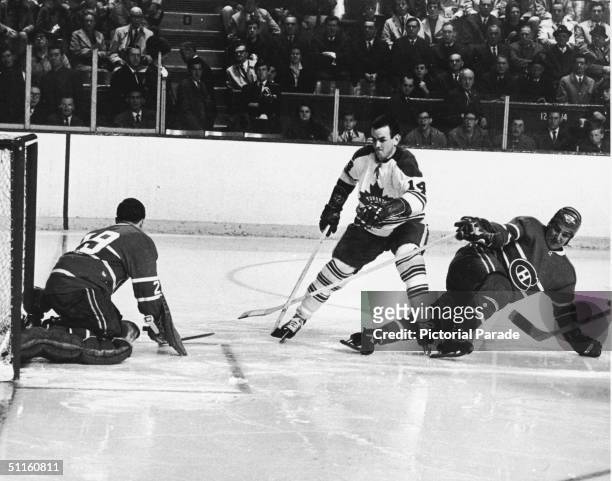 Dave Koen of the Toronto Maple Leafs tries to elude the Montreal Canadien defense and goalkeeper Rogatien Vachon , during the second game of the 1967...