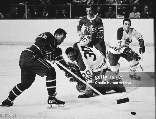 During game one of the 1967 Stanley Cup finals, Toronto Maple Leafs goalkeeper Terry Sawchuk watches as Montreal Canadien Yvan Cournoyer as Maple...