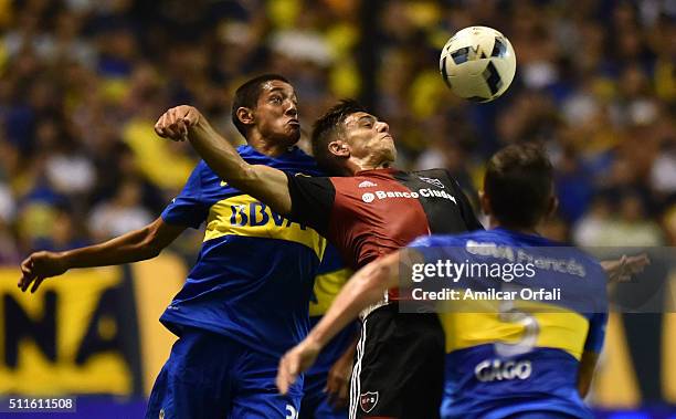 Nahuel Molina Lucero of Boca Juniors fights for the ball with Ignacio Scocco of Newell's during the 4th round match between Boca Juniors and Newell's...