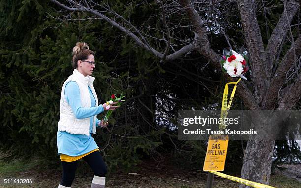 Woman places flowers at a Cracker Barrel where a gunman went on a shooting rampage, on February 21, 2016 in Kalamazoo, Michigan. Authorities said...