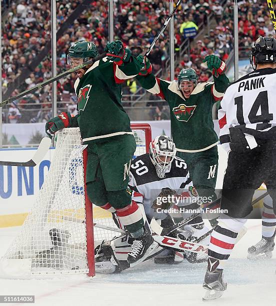 Matt Dumba of the Minnesota Wild celebrates his goal along with Ryan Carter at 3:25 of the first period against Corey Crawford of the Chicago at the...