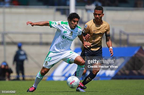 Francisco Meza of Pumas struggles for the ball with Martin Bravo of Santos Laguna during the 7th round match between Pumas UNAM and Santos Laguna as...