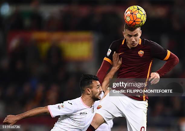 Roma's forward from Bosnia-Herzegovina Edin Dzeko heads the ball to score during the italian Serie A football match Roma vs Palermo at the Olympic...