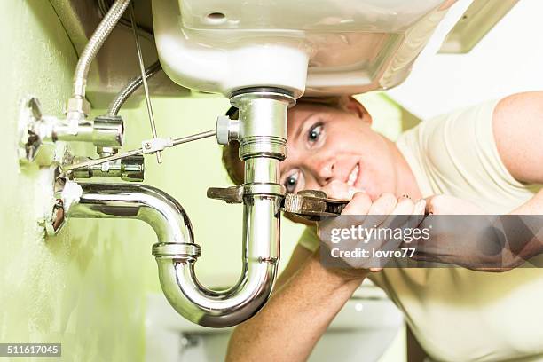 housewife repairing a siphon under the sink - diy disaster stock pictures, royalty-free photos & images