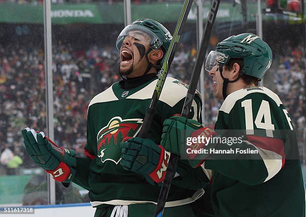 Matt Dumba of the Minnesota Wild celebrates his goal along with Justin Fontaine at 3:25 of the first period against the Chicago at the TCF Bank...