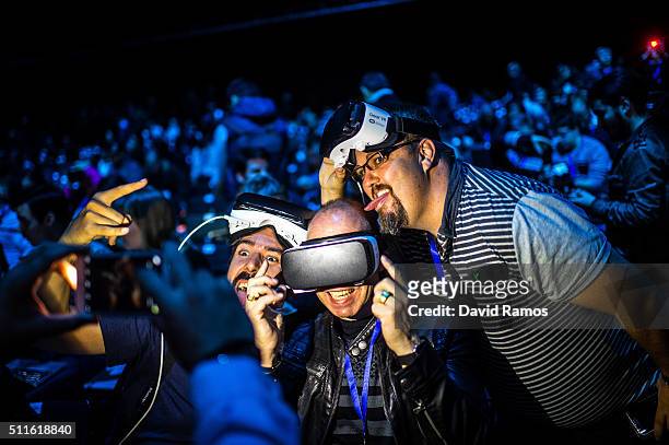 People pose for a picture as they wear Samsung Gear VR devices during the presentation of the new Samsung Galaxy S7 and Samsung Galaxy S7 edge on...